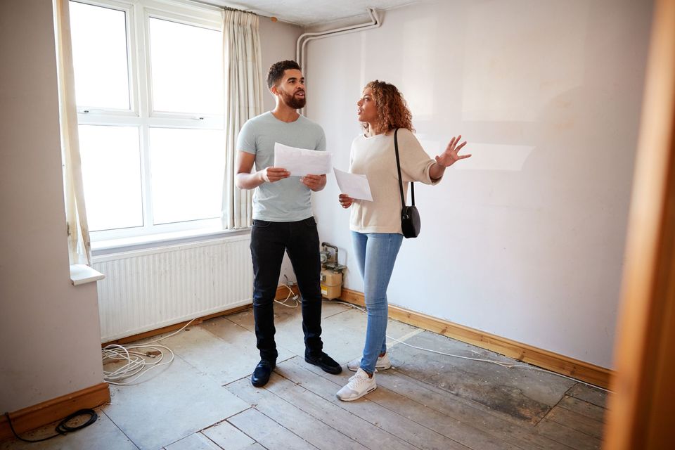 Couple looking at a house to buy and thinking about a survey of lead and lead solder Couple looking at a house to buy and thinking about a survey of lead and lead solder